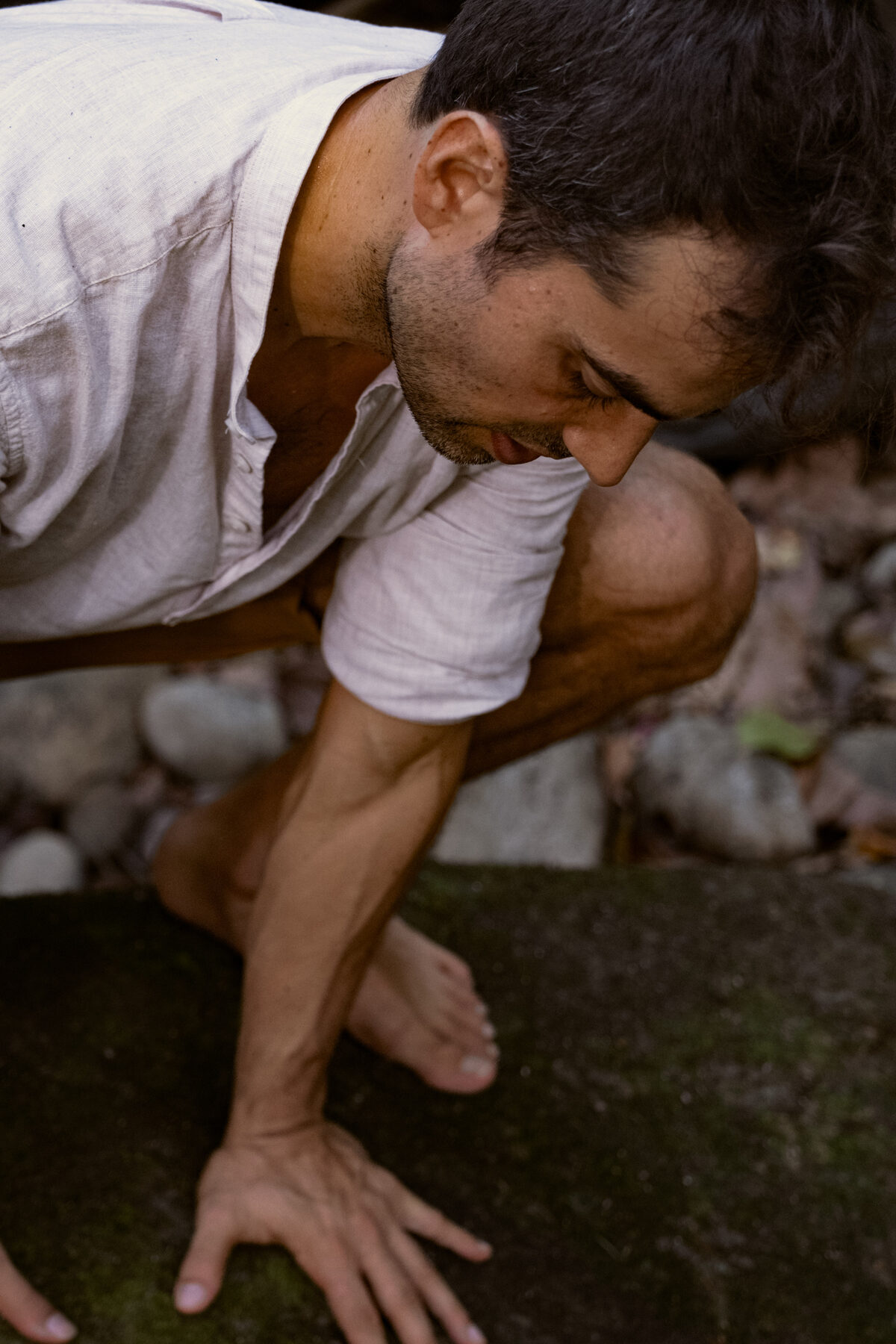 David grounded on mossy stone, barefoot